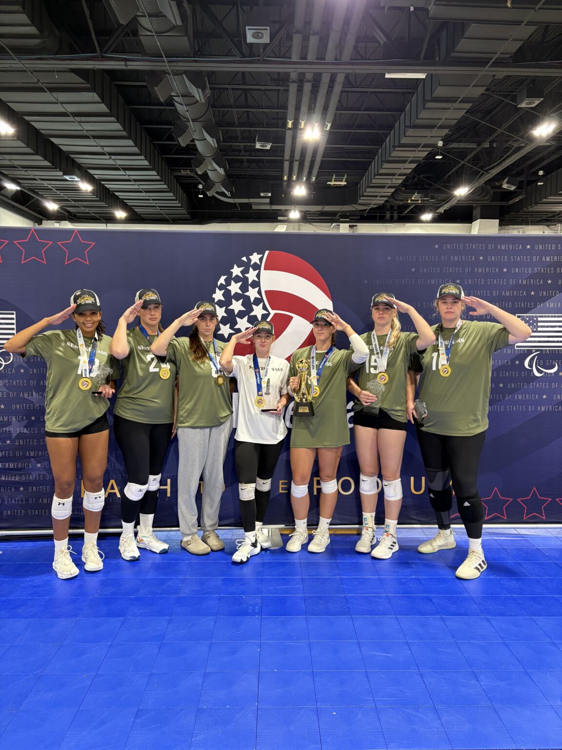 Junior volleyball team on the awards podium wearing medals